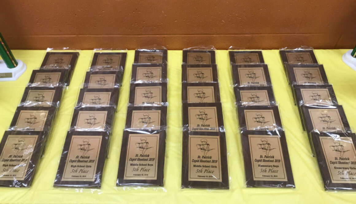 Table full of student awards and plaques