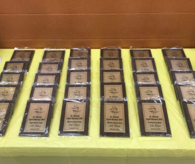 Table full of student awards and plaques