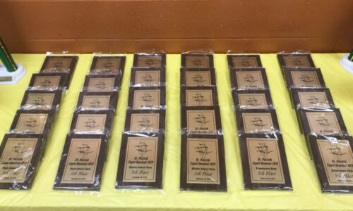 Table full of student awards and plaques