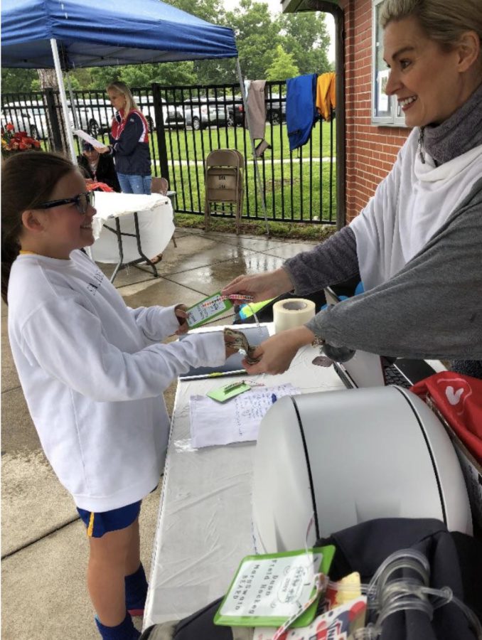 At fundraisers for schools woman selling window decals to a student