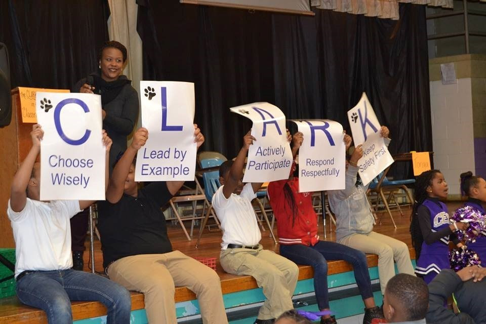 children engage with posters used for learning